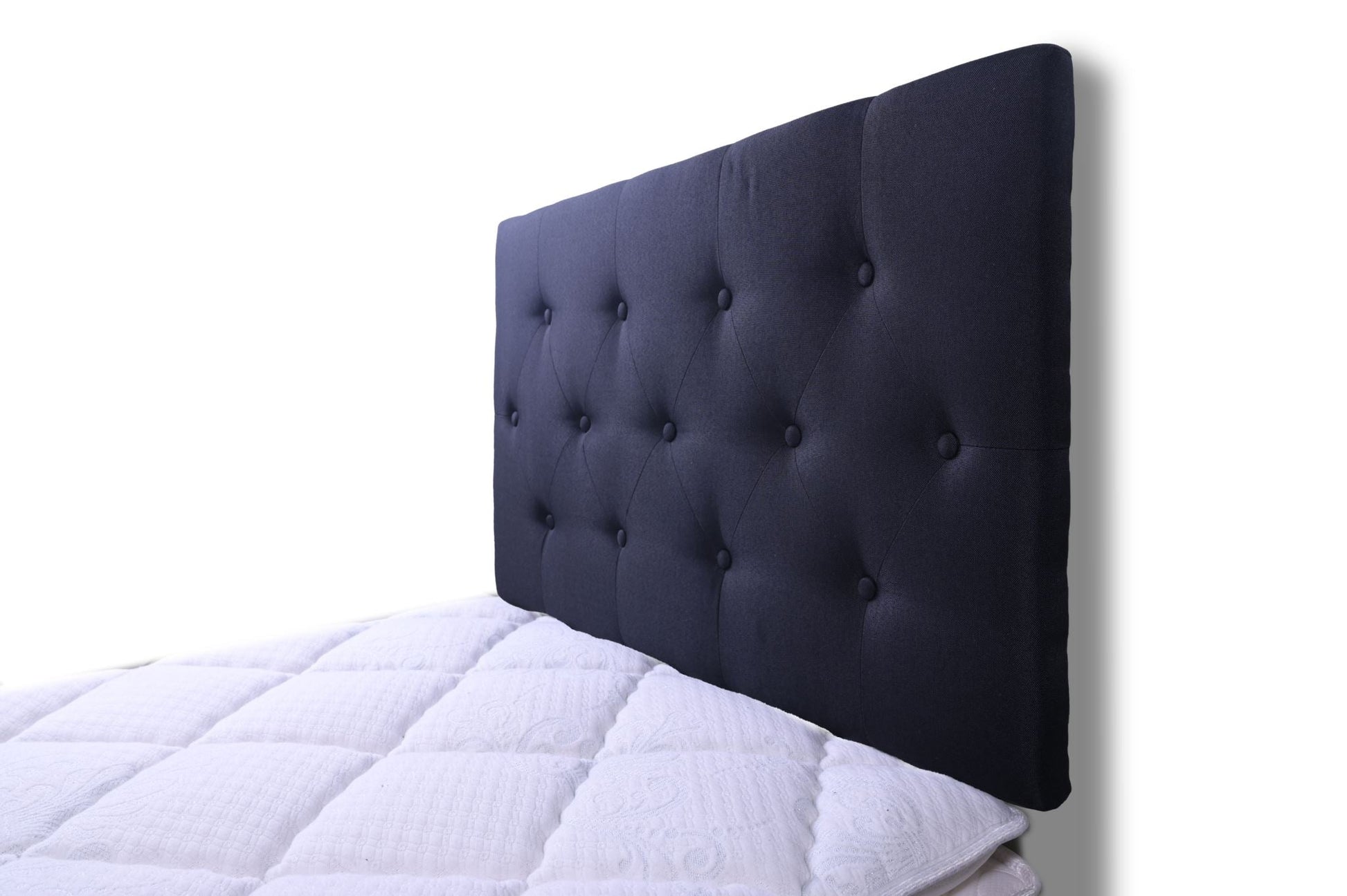Black single Fenland headboard by sue-e furniture, showcasing a sleek, modern design with a smooth, upholstered surface.