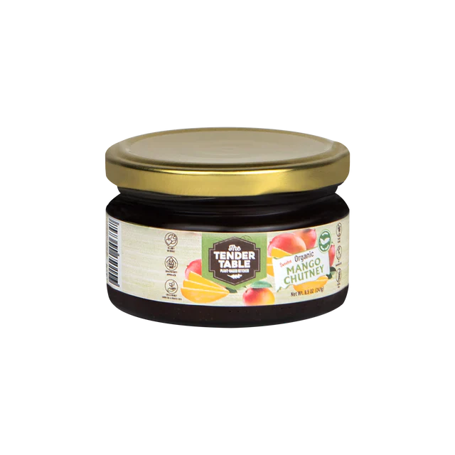 Organic mango chutney in a jar, showcasing vibrant orange color and smooth texture, ideal for condiments and flavor enhancement.