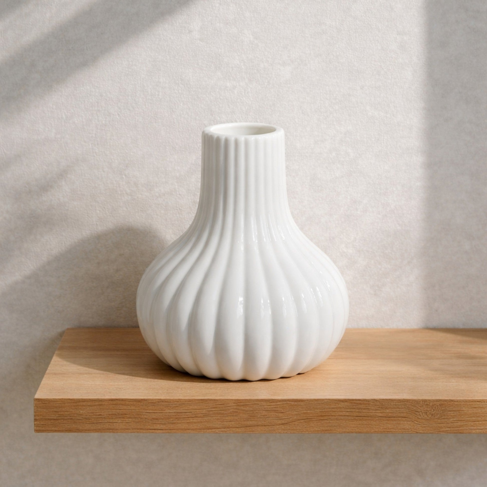 White fluted ceramic bud vase from Nest & Stem Homewares, designed for small floral arrangements and decorative display.