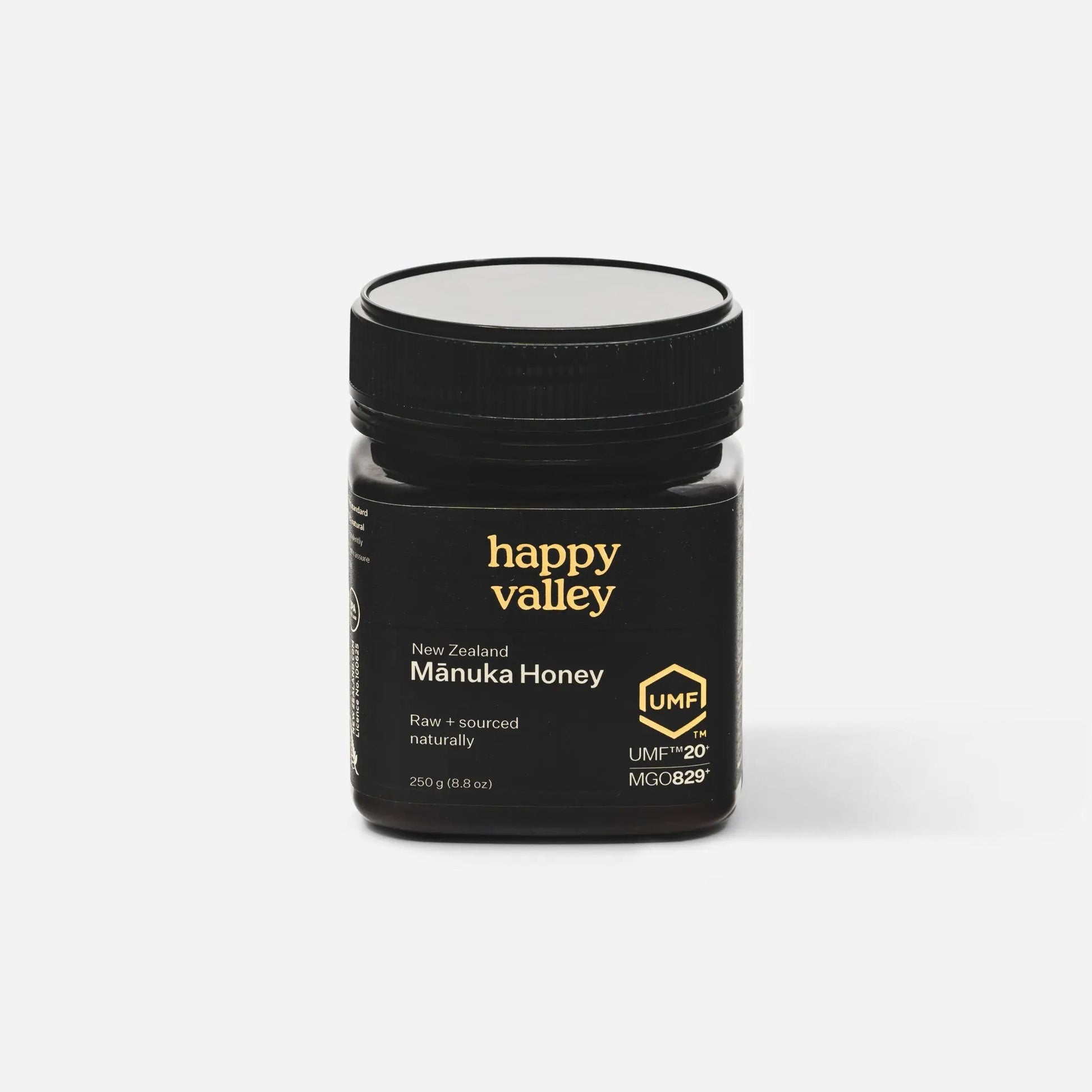 Jar of Happy Valley Honey Mānuka Honey UMF® 20+ with golden honey visible in a clear glass jar.
