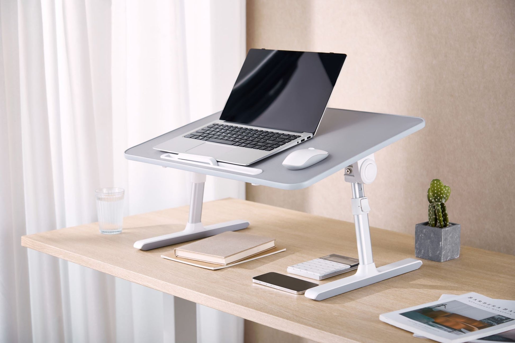 Foldable Ergomax laptop desk from sue-e furniture with a sleek wooden surface and foldable legs, ideal for portable office use.