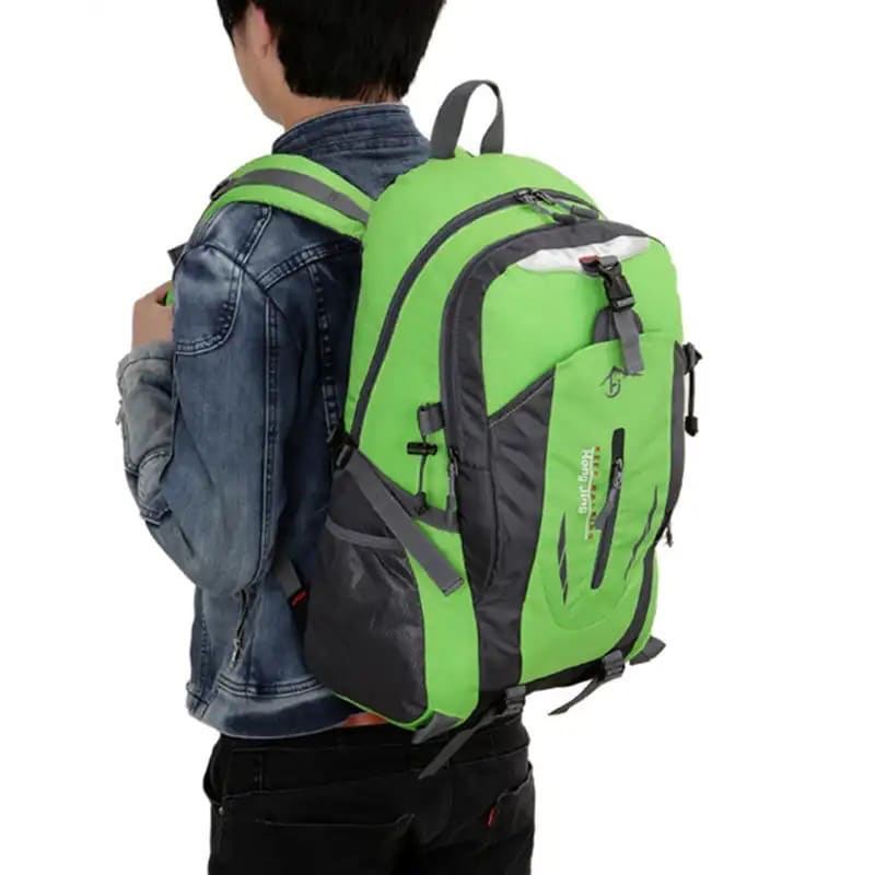 Green and black 9eight5 backpack with multiple compartments and adjustable straps, ideal for school or travel use.