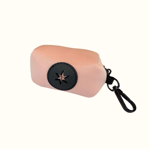 Blush pink Walkieez dog poop bag dispenser holder with a compact design, showing the dispenser attached to a leash.