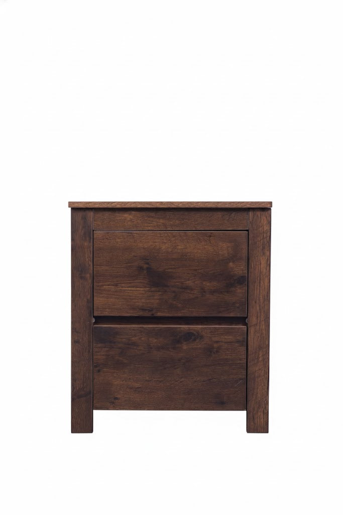Dark oak Byron bedside table by sue-e furniture with a sleek design and a single drawer, placed next to a bed in a modern bedroom.