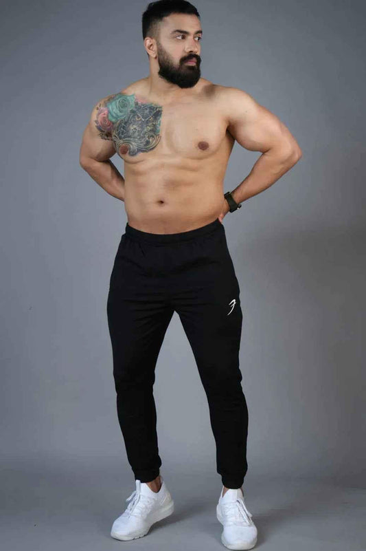 Black nylon joggers by Fuaark Nz featuring a relaxed fit and adjustable waistband, perfect for casual wear.