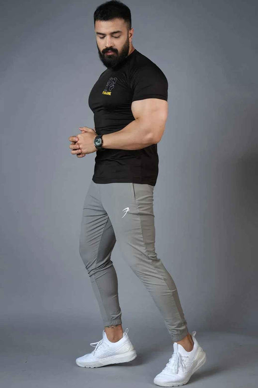 Light grey nylon joggers from Fuaark Nz featuring a relaxed fit and elastic waistband, designed for comfortable casual wear.