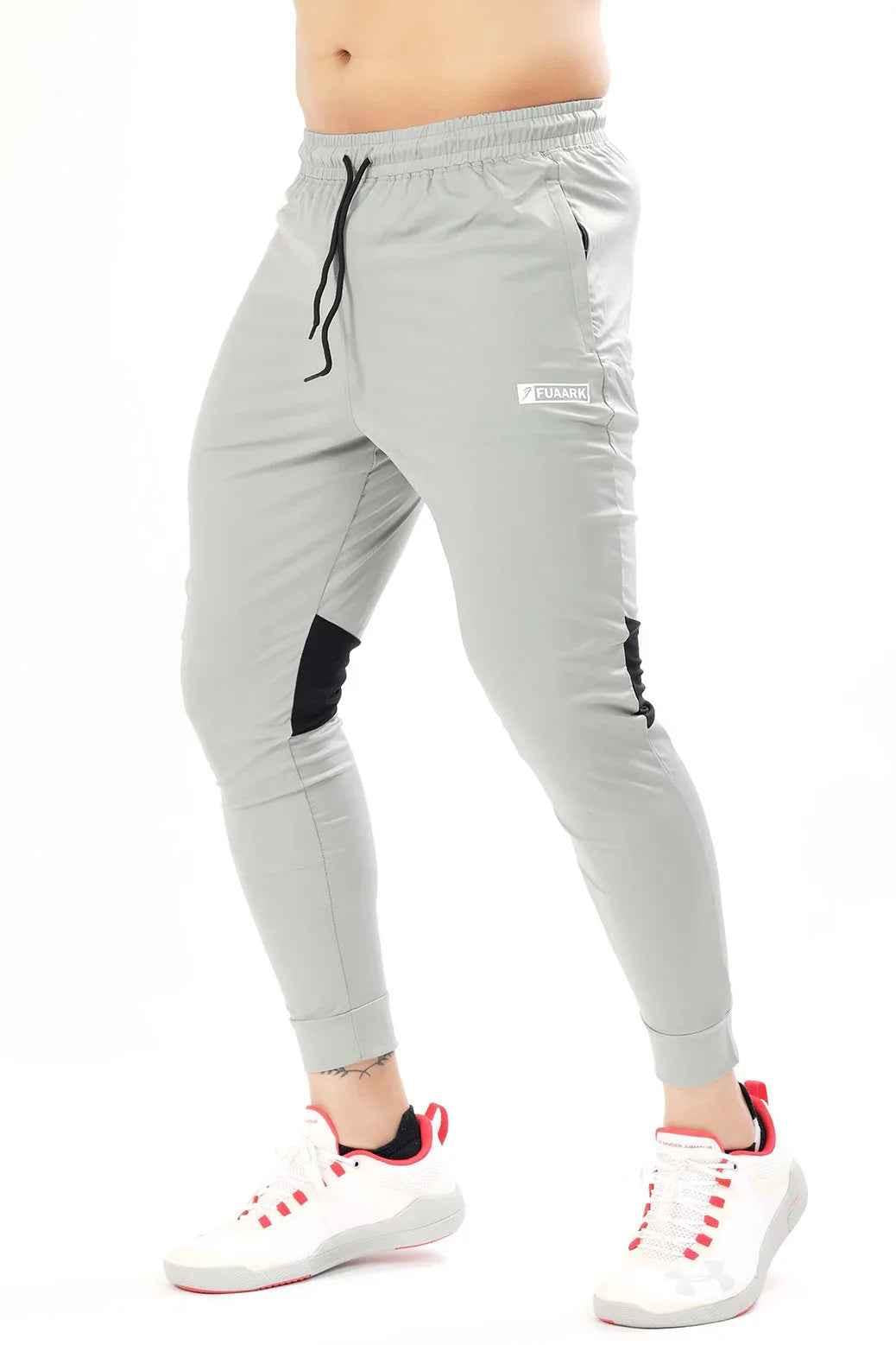 Light grey nylon joggers by Fuaark Nz featuring a comfortable fit and stylish design for casual wear.