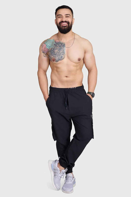 Black Fuaark Nz Script Cargo Joggers with multiple pockets and relaxed fit, displayed on a model.