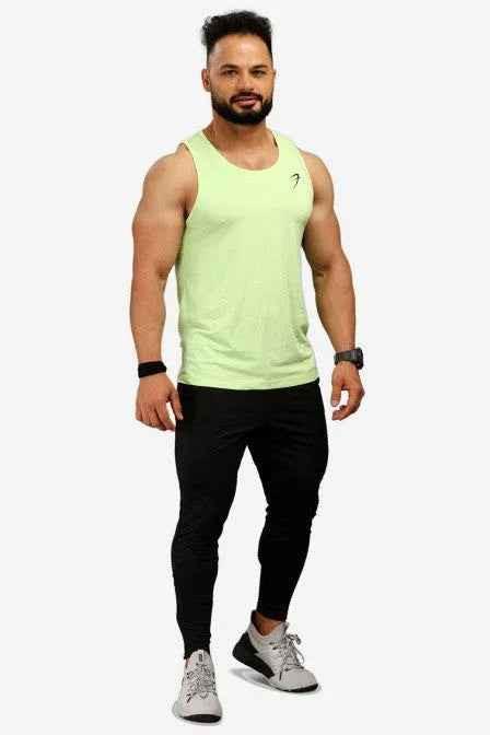Men's lime tank top by Fuaark Nz, lightweight and stylish summer essential, shown on a model with a casual outdoor background.