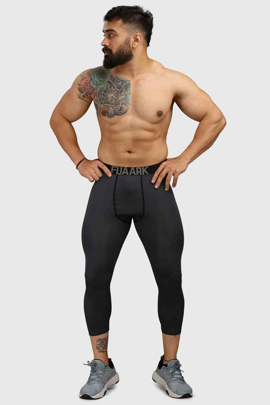 Dark grey Fuaark Nz compression tights, close-up view showing the snug fit and stretchy fabric for athletic support.