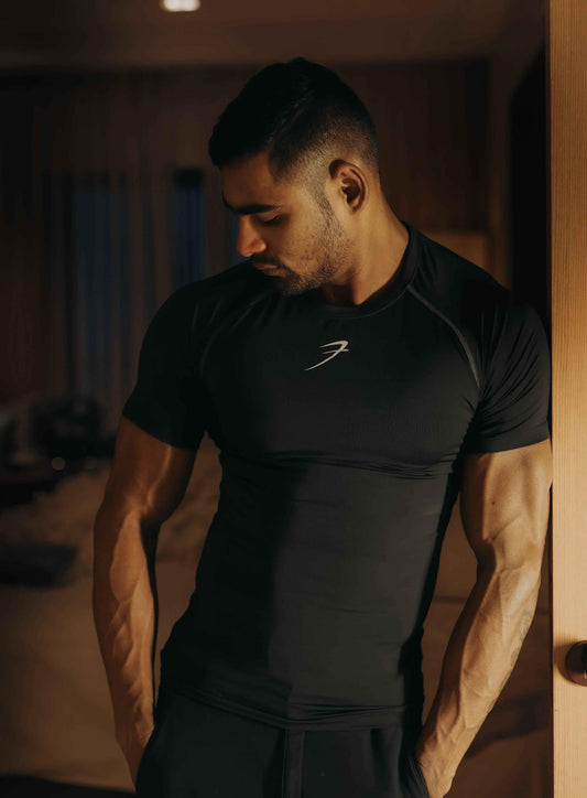 Black compression T-shirt by Fuaark NZ, featuring a snug fit and breathable fabric, perfect for athletic wear.