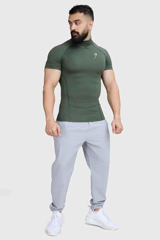 Olive high neck compression T-shirt by Fuaark Nz, close-up of fitted athletic shirt with high neckline and smooth fabric.