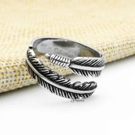 Silver stainless steel feather ring by Glitters, featuring detailed feather design and smooth band for stylish wear.