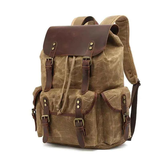 Black waxed canvas computer travel bag with leather accents, Mead's Supply & Equipment Outfitters 20-35L laptop backpack for work and school.