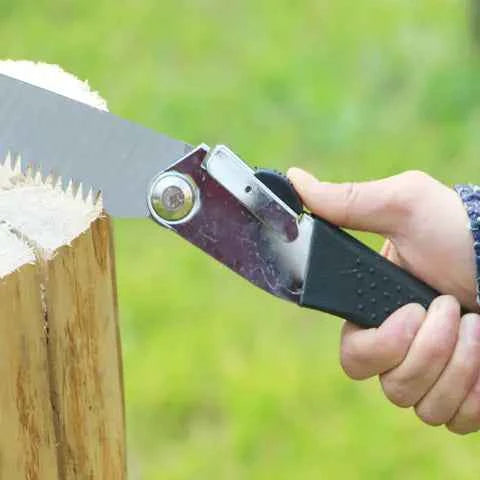 Portable folding hand saw by Mead's Supply for outdoor gardening and woodworking, featuring a compact design and sharp cutting blade.