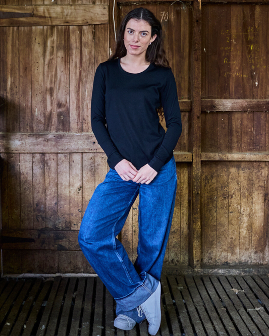 Women's black merino wool long sleeve shirt by Merino 365 NZ, made from 100% Merino wool, shown on a model.