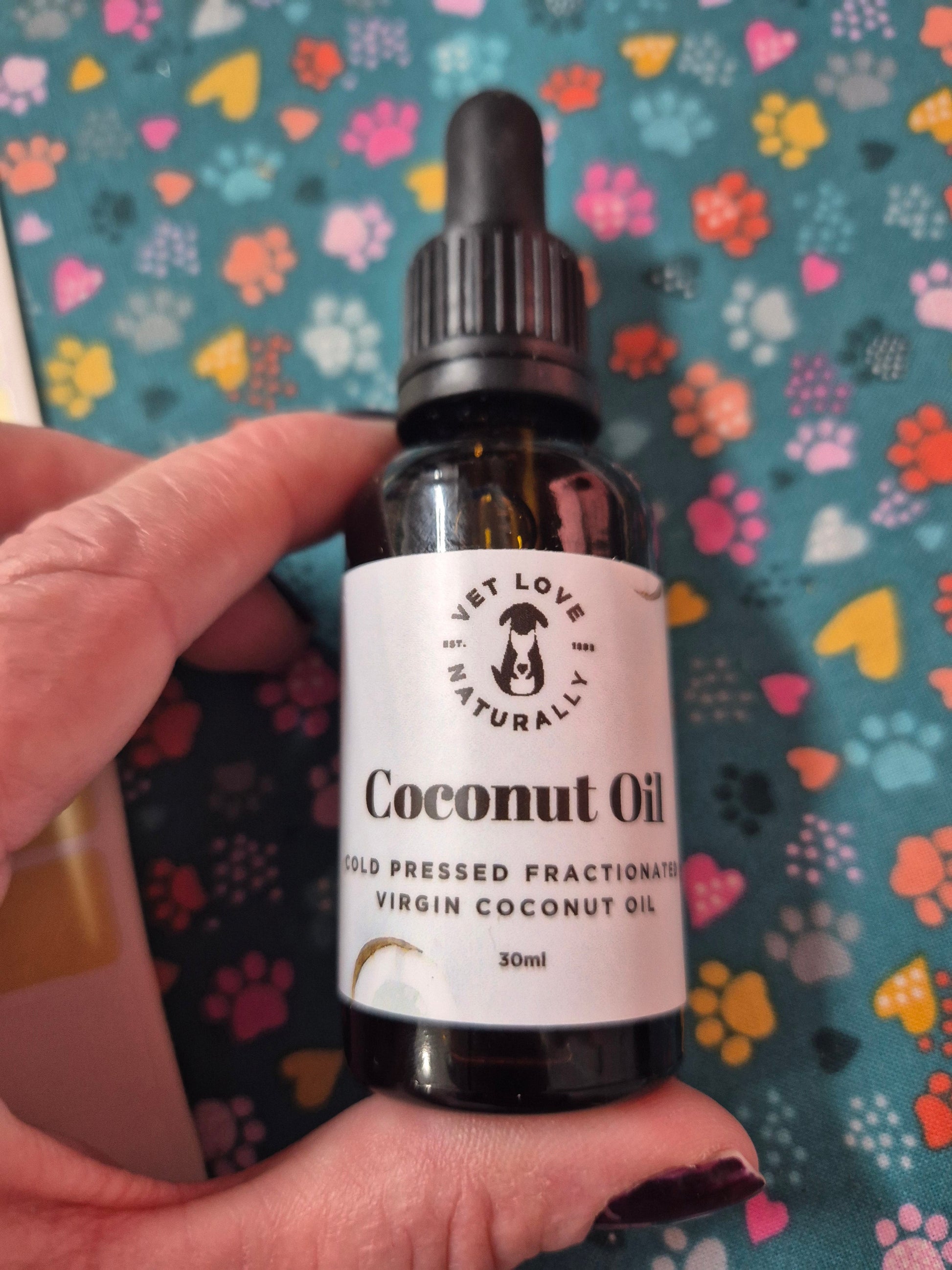 Organic coconut oil from Animal Addiction Limited in a clear jar, showing the white, solid coconut oil inside.