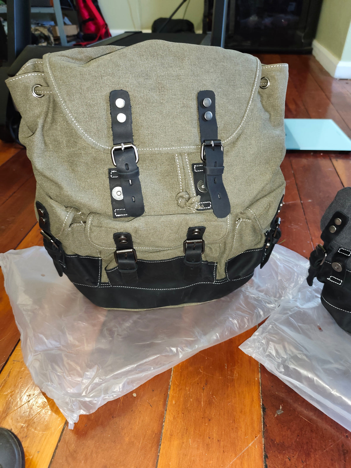 Waxed canvas leather backpack by Mead's Supply, featuring a retro heritage design, leather accents, and multiple compartments for travel.
