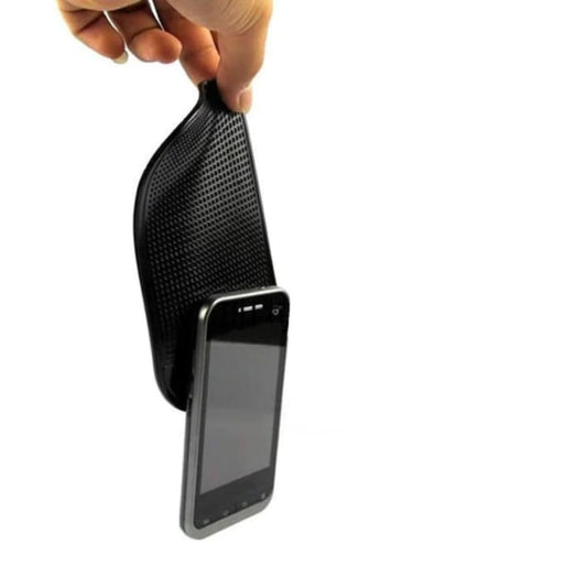 9eight5 car dashboard anti-slip mat holding phone and tablet securely on a vehicle dashboard.