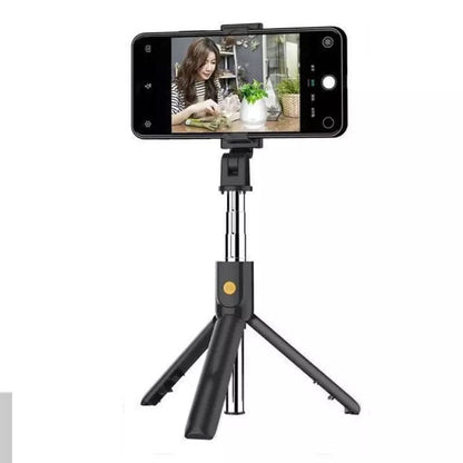 9eight5 selfie stick with remote and stand for phones and tablets, showing the extendable stick and remote control in hand.