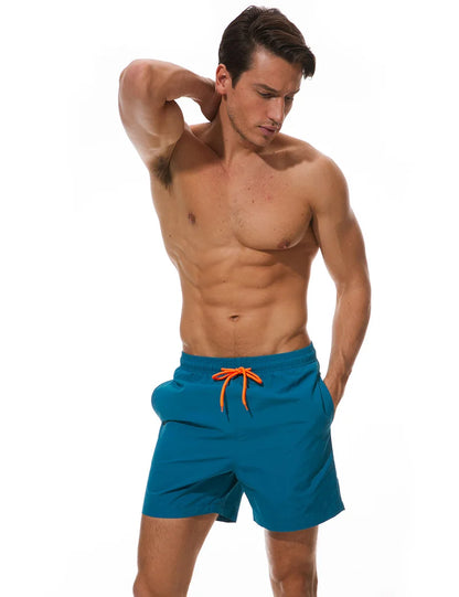 Men's blue surf board shorts with quick-dry fabric, athletic fit, and adjustable waistband, perfect for beach and swimming activities.