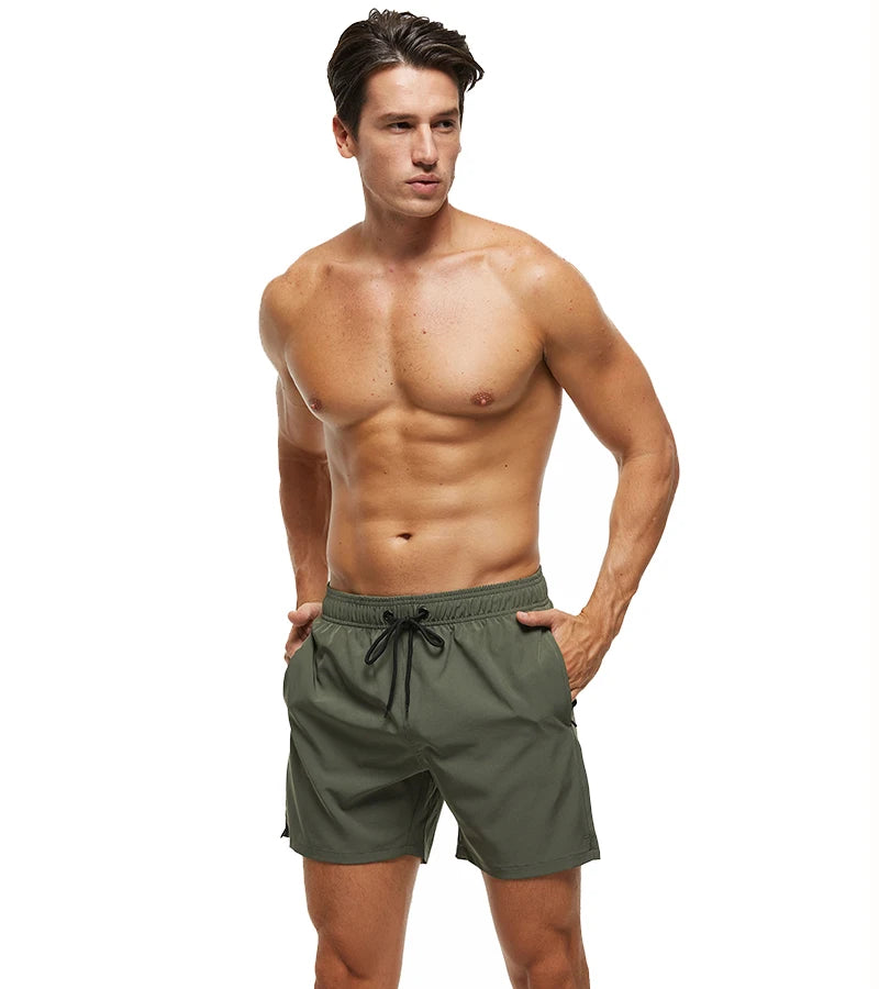 Men's Datifer Summer 2026 shorts with solid color design, mesh liner, zipper pockets, quick-dry fabric, ideal for beach and gym.