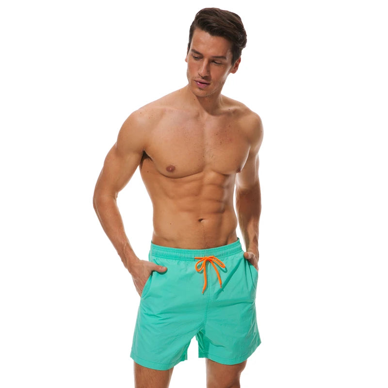 Men's beach boardshorts by ShopHub NZ featuring vibrant surfing-style swimwear with a sporty Bermuda cut and quick-dry fabric.