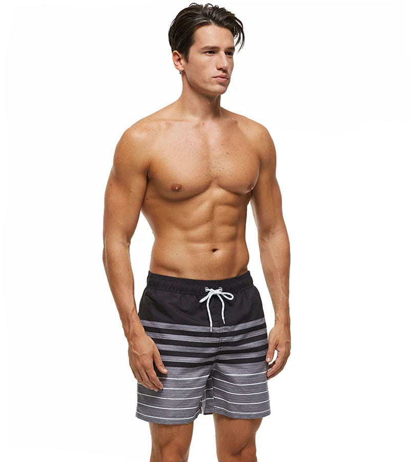 Men's polyester boardshorts by ShopHub NZ featuring quick-dry fabric, colorful print, mesh liner, suitable for beach, surfing, and gym.