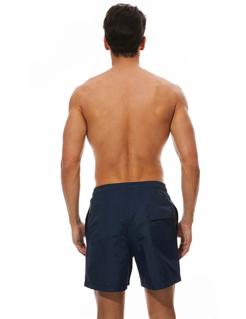 Men's surfboard shorts by ShopHub NZ, stylish beach swimwear with vibrant print, perfect for surfing and beach activities.