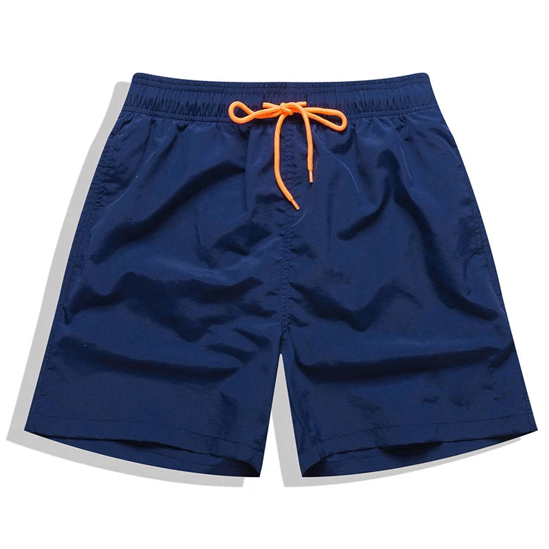 Men's beach boardshorts by ShopHub NZ featuring sporty surfing style, lightweight fabric, and vibrant color for ocean swimming and beach activities.