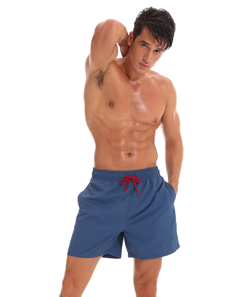 Men's beach boardshorts by ShopHub NZ, stylish surfing swim shorts with a comfortable fit and vibrant seaside design.