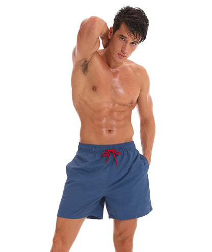 Men's beach boardshorts by ShopHub NZ, stylish surfing swim shorts with a comfortable fit and vibrant seaside design.