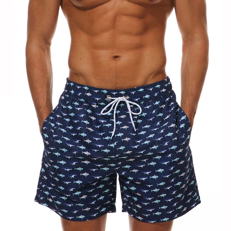 Men's polyester boardshorts with quick-dry fabric, colorful print, mesh liner, suitable for beach surfing and gym activities.
