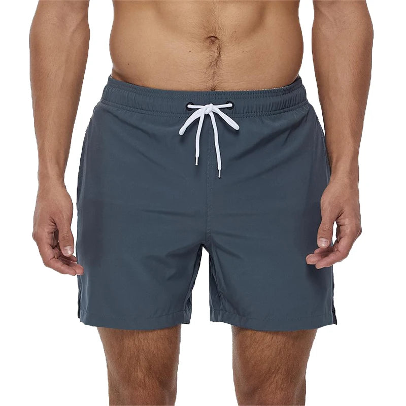 Men's Datifer Brand 2026 summer boardshorts with solid polyester fabric, breathable mesh liner, side pockets, and sporty design.