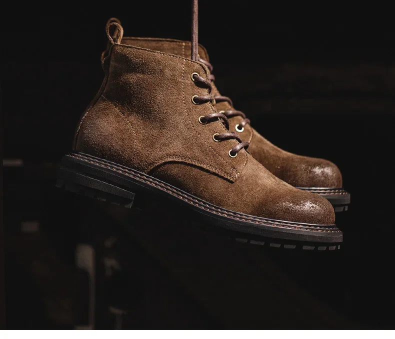 Brown suede boots on a dark background
