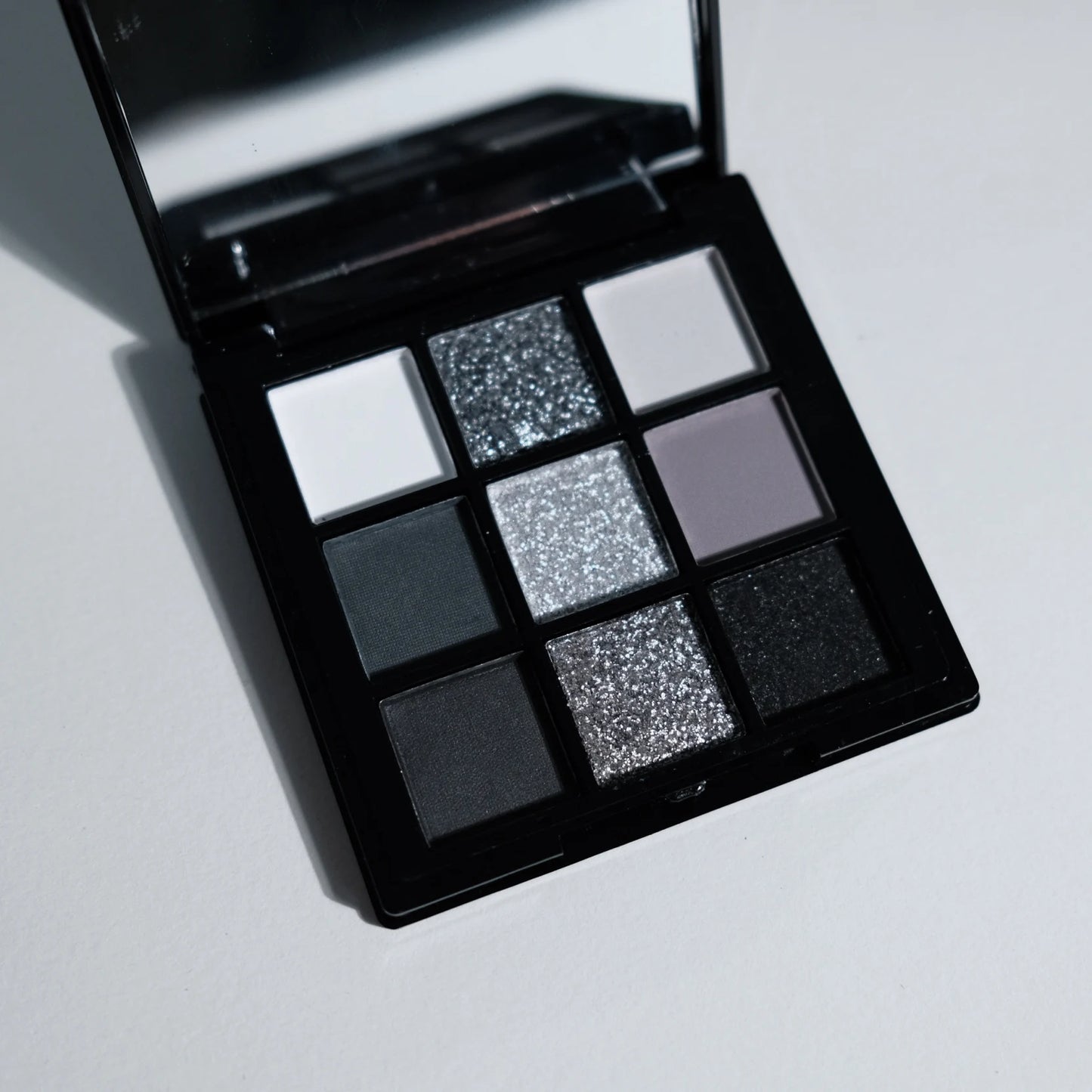 ShopHub NZ 9-colours eyeshadow palette with a variety of vibrant and neutral shades for versatile makeup looks.
