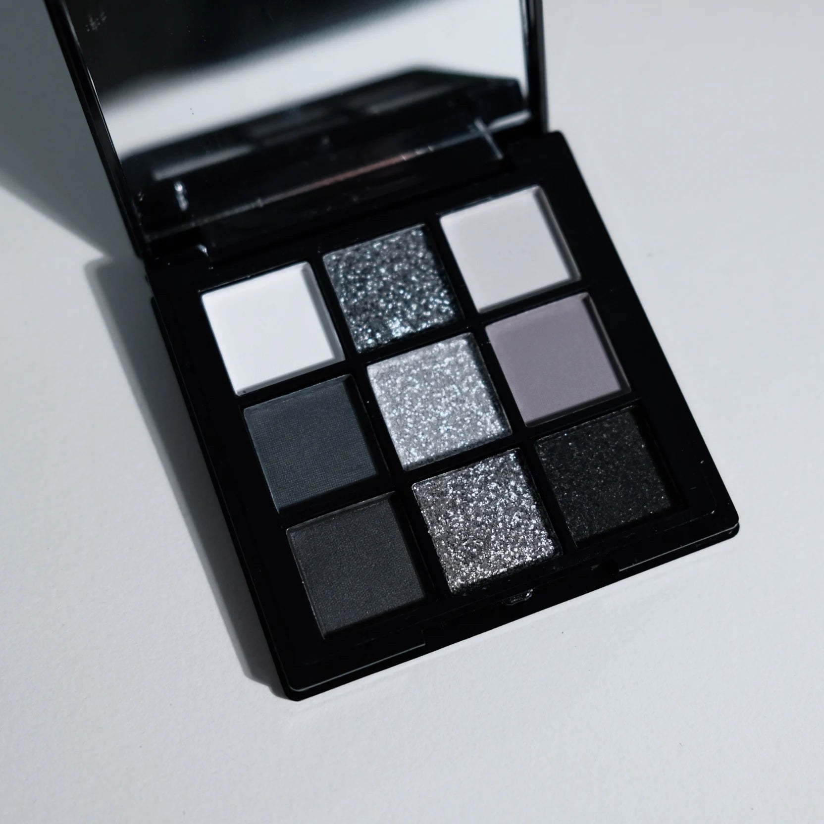 ShopHub NZ 9-colours eyeshadow palette with a variety of vibrant and neutral shades for versatile makeup looks.