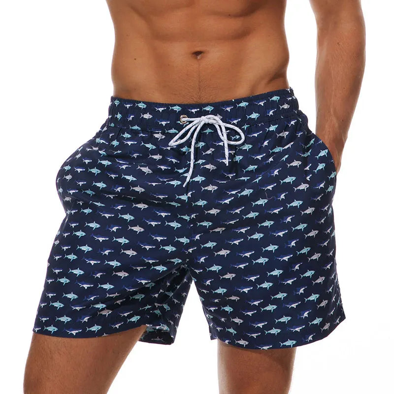 Men's polyester boardshorts with colorful surfing print, ideal for beachwear, swimming, and fitness activities.