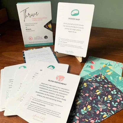Thrive Daily Wellness Card Deck for Kids aged 9+ by Awesome Inc NZ, showing colorful cards with positive prompts and illustrations.