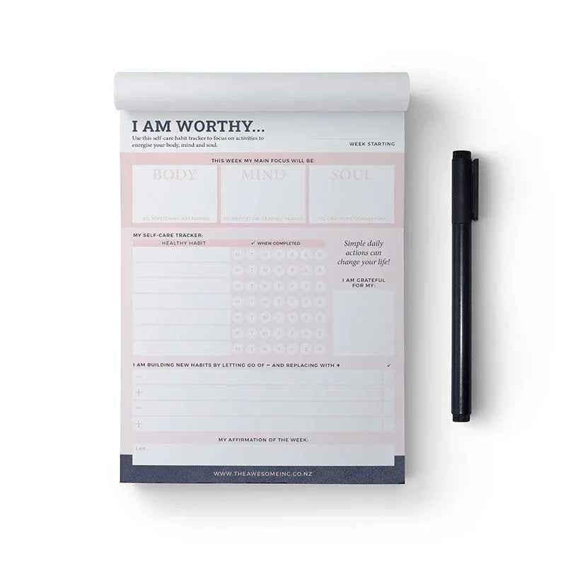Self-care habit tracker notepad by Awesome Inc NZ with "I Am Worthy" message, designed for tracking daily self-care routines.
