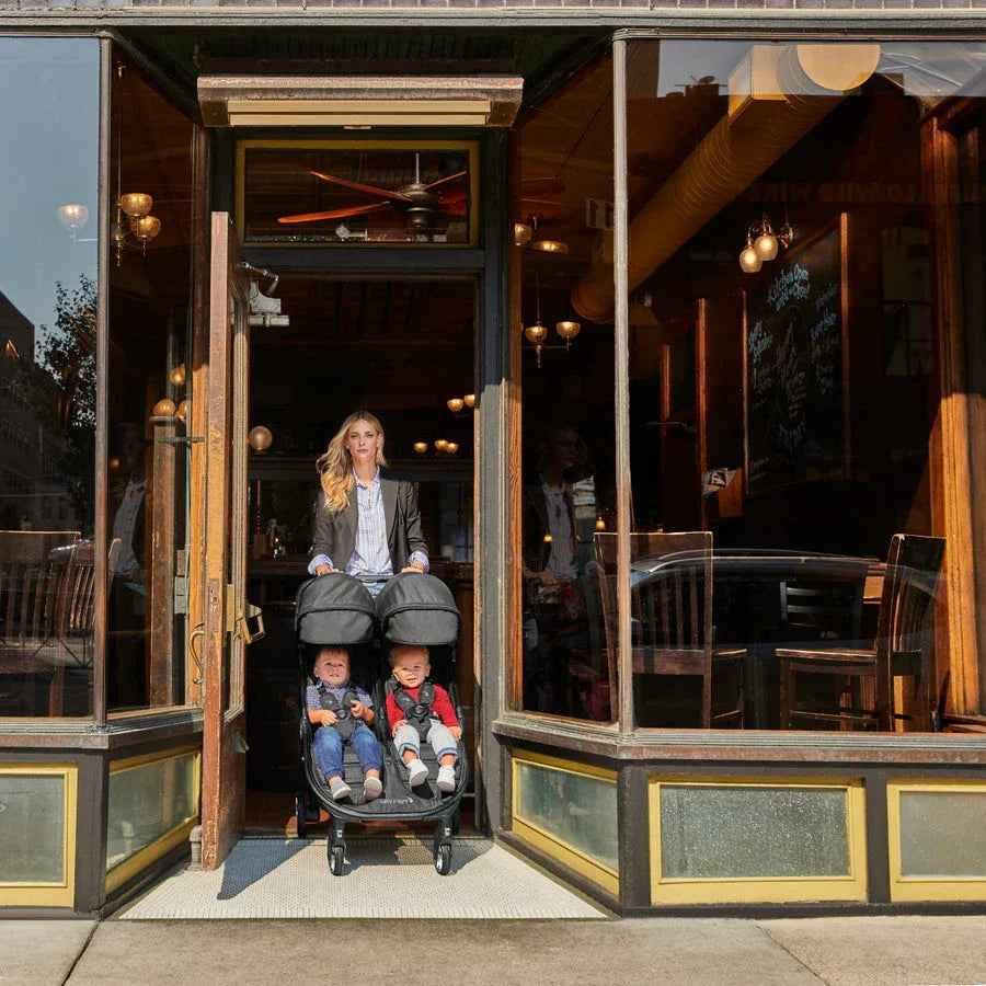 Baby Jogger City Tour 2 Compact Double Stroller in Pitch Black, lightweight and easy to maneuver for two children.