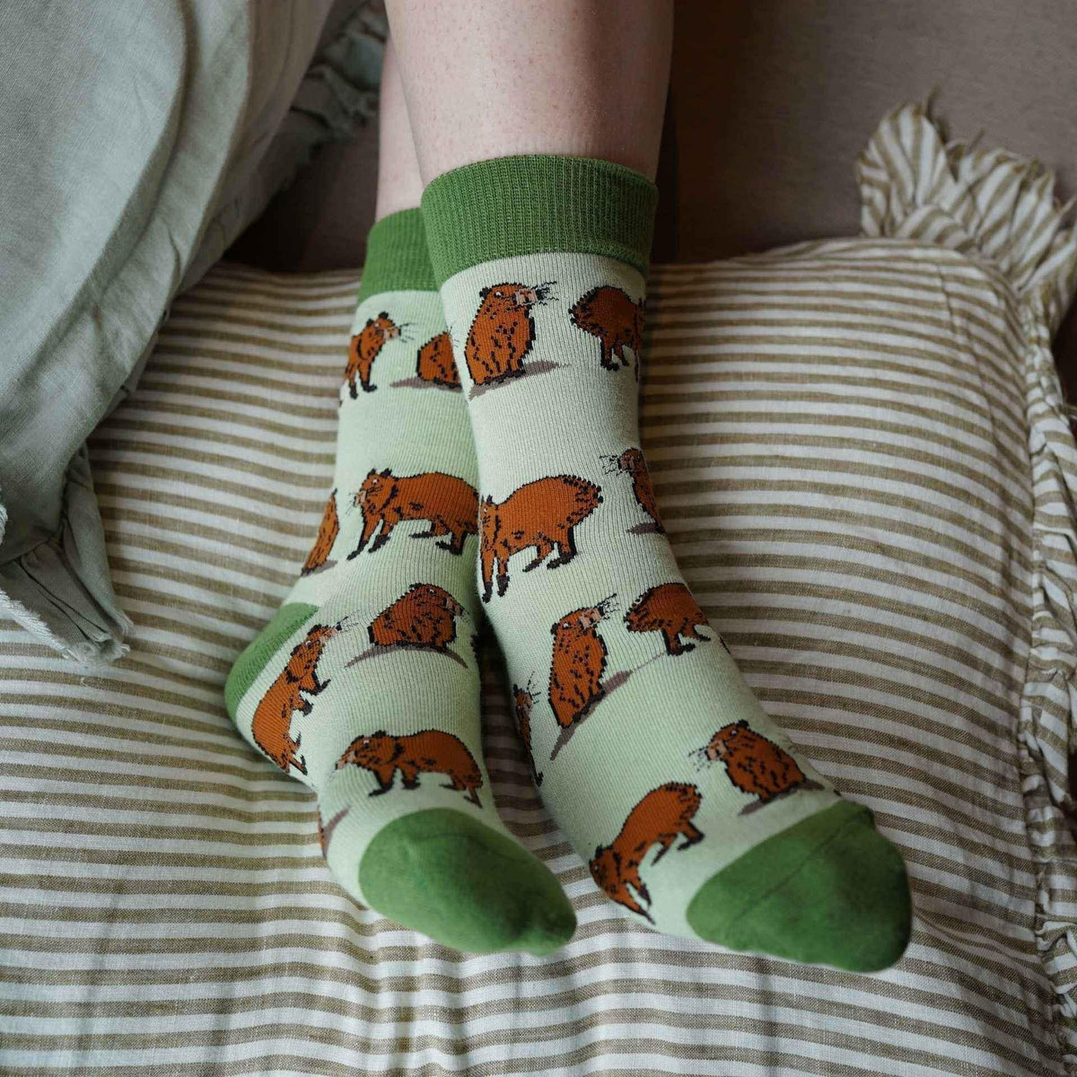 Barekind NZ bamboo socks featuring a green capybara design, perfect for comfortable, eco-friendly footwear for adults.