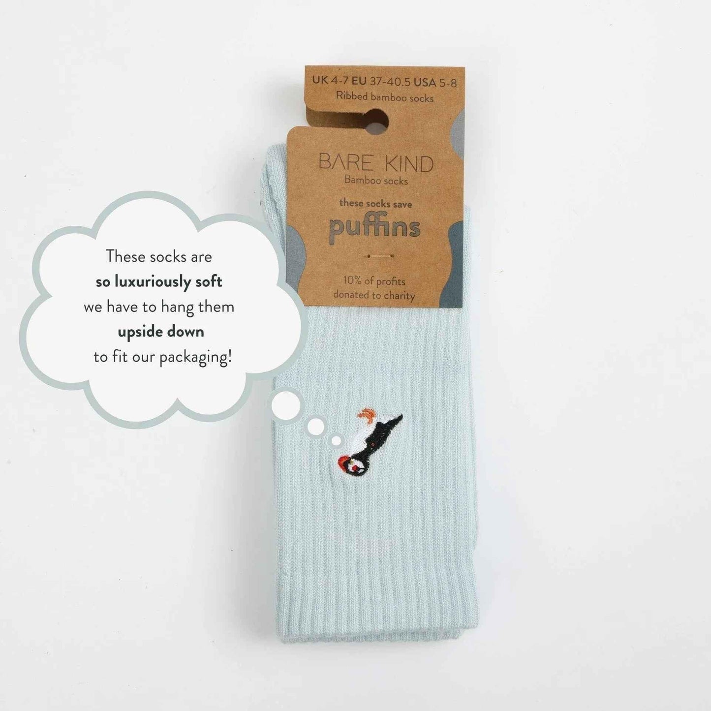 Pair of Barekind NZ Save the Puffin ribbed bamboo socks for adults, featuring a cozy, textured design in natural tones.