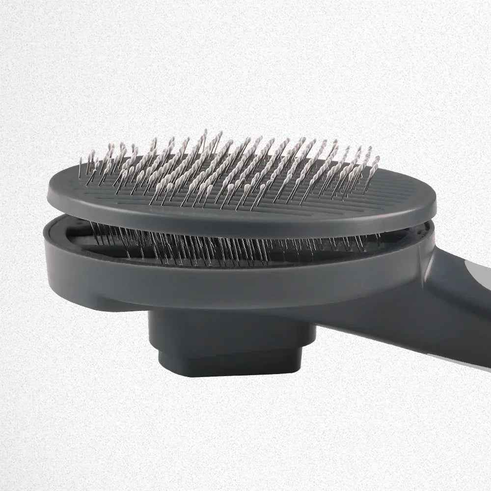 Self-cleaning slicker pet brush from Cool Kitty Cat Litter, with fine metal bristles for gentle grooming and easy cleaning.