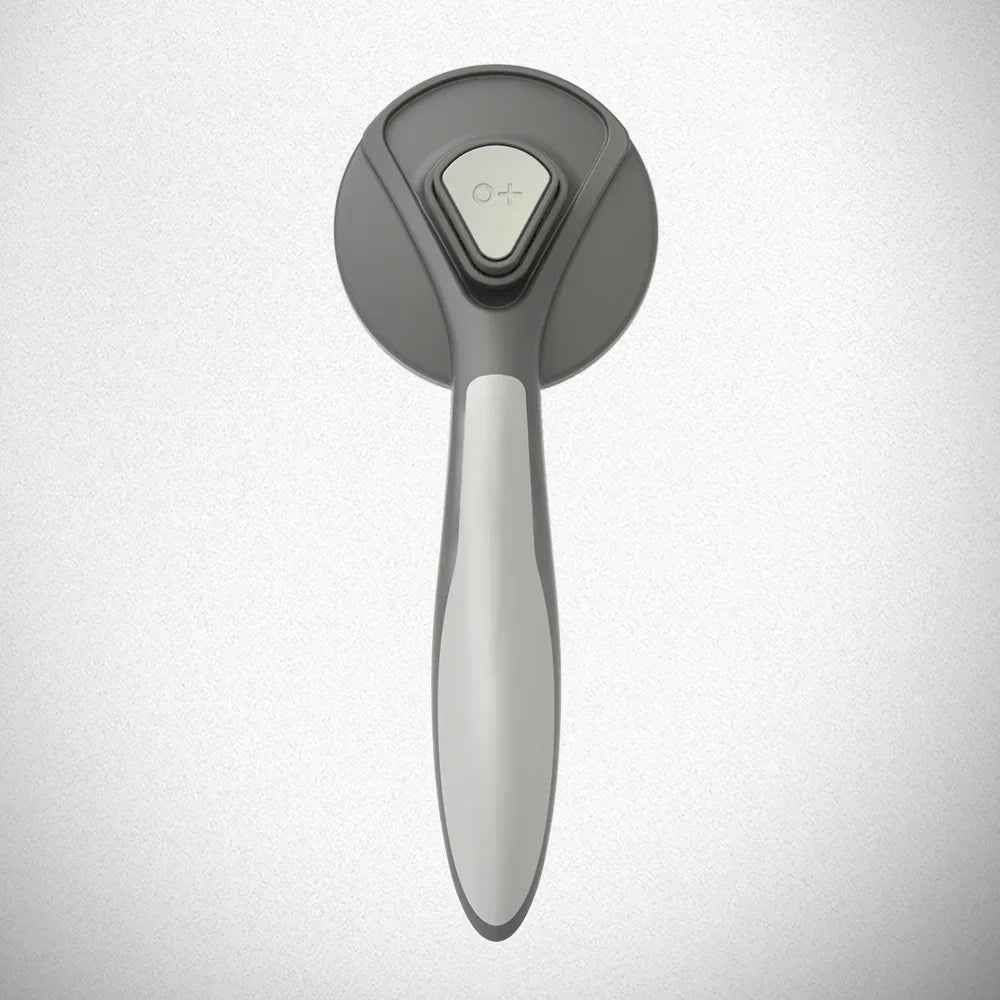 Self-cleaning Slicker Brush for pets by Cool Kitty Cat Litter, showing the brush with fine metal bristles and ergonomic handle.