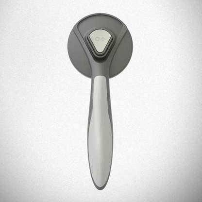Self-cleaning Slicker Brush for pets by Cool Kitty Cat Litter, showing the brush with fine metal bristles and ergonomic handle.