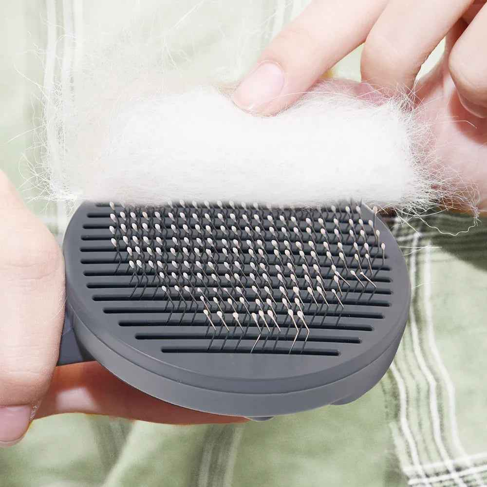 Self-cleaning Slicker Pet Brush by Cool Kitty Cat Litter for removing loose fur and detangling cats and small dogs.