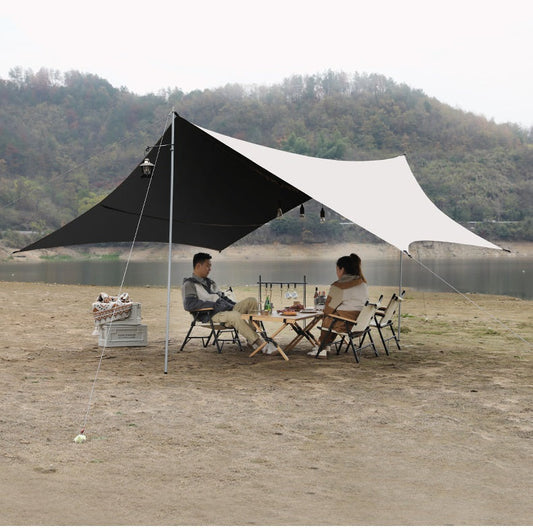 Large black butterfly-style ECOTREK waterproof blackout canopy set up outdoors, showcasing its portable and durable design.