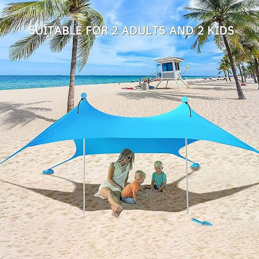 Green ECOTREK portable beach canopy sun shade awning providing shelter and shade for outdoor relaxation at the beach.