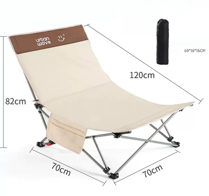 Black ECOTREK portable folding beach chair with enhanced size and comfort, shown folded and ready for outdoor use.